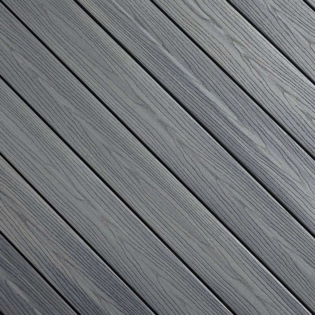 Close-up of Fiberon GoodLife Beach House composite decking board, showcasing its multi-tonal sandy brown grain and durable three-sided cap layer.