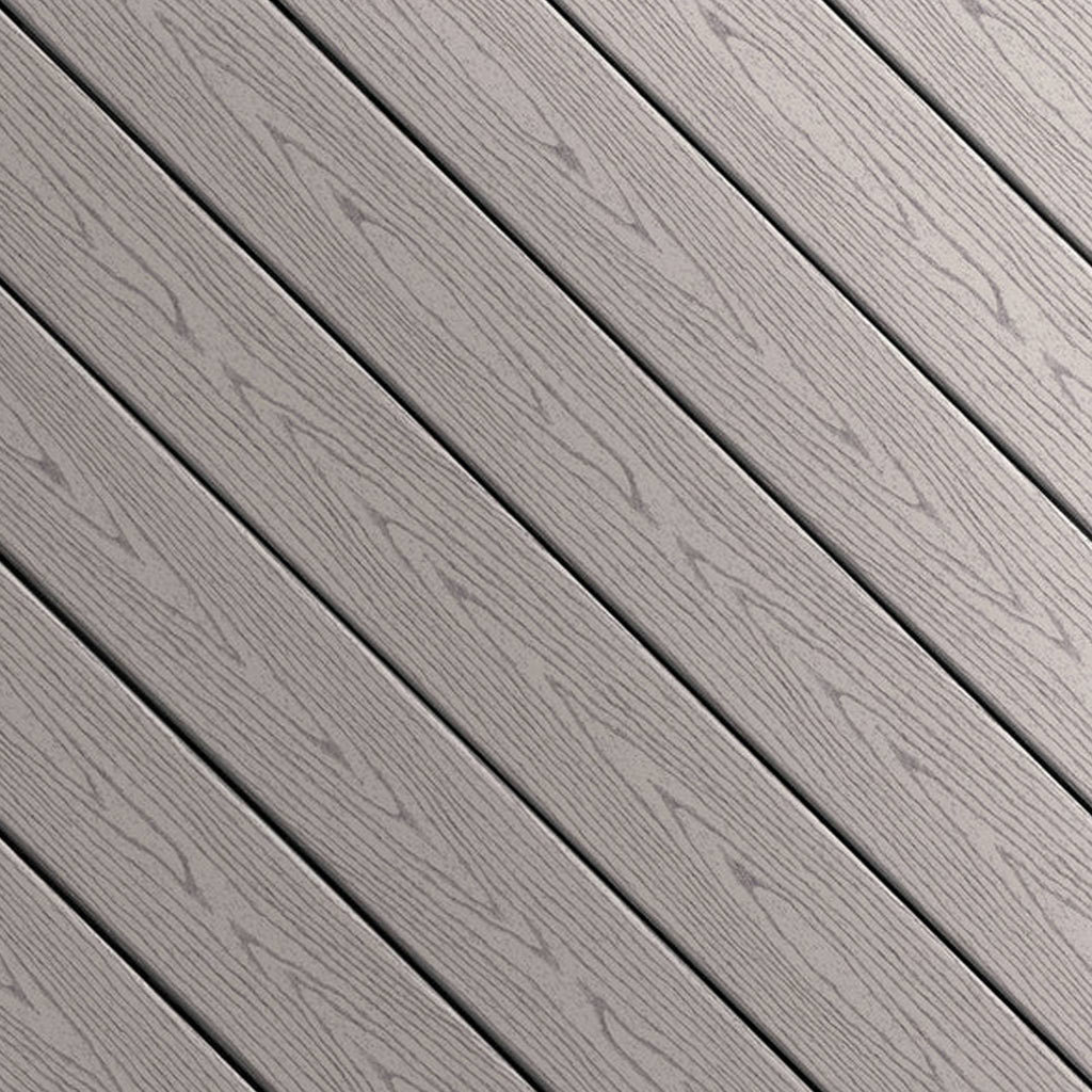 Close-up of Fiberon GoodLife Cottage composite decking board from the Weekender Series, showing its solid gray wood-grain texture and protective cap.