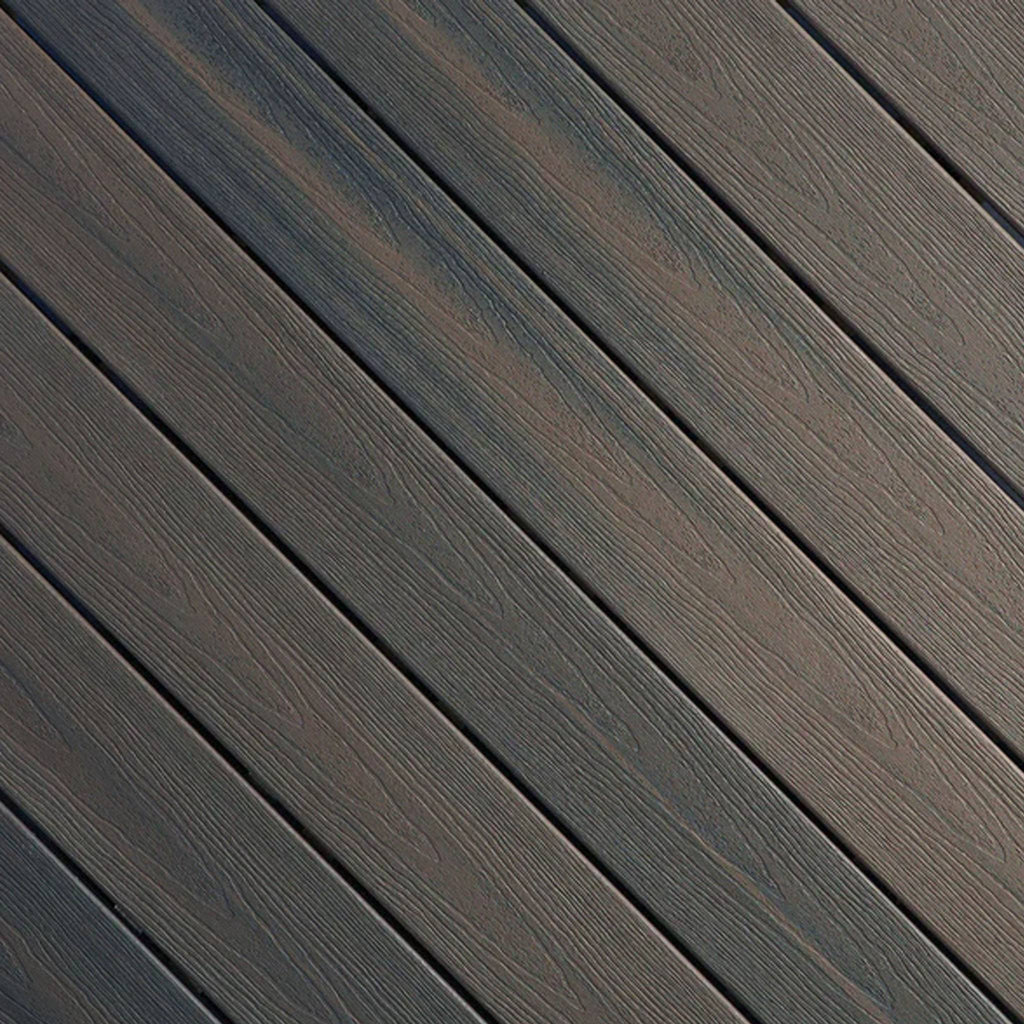 Close-up of Fiberon Sanctuary Latte composite decking, showcasing its warm light-brown multi-tonal grain and rustic embossed surface texture.
