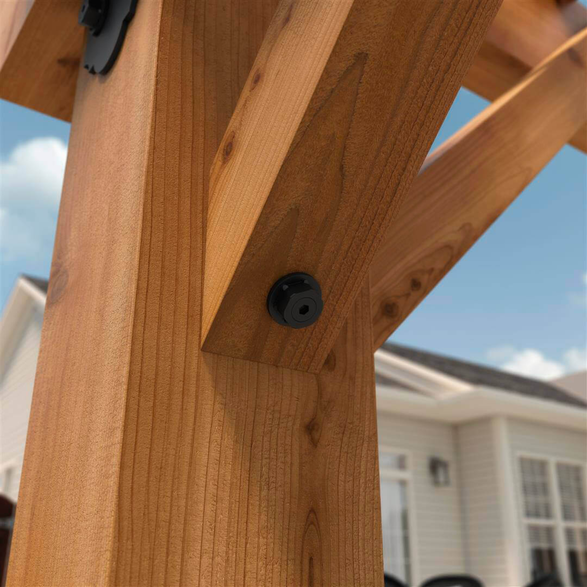 OZCO hex cap nut installed on exposed timber beam connection in outdoor structure