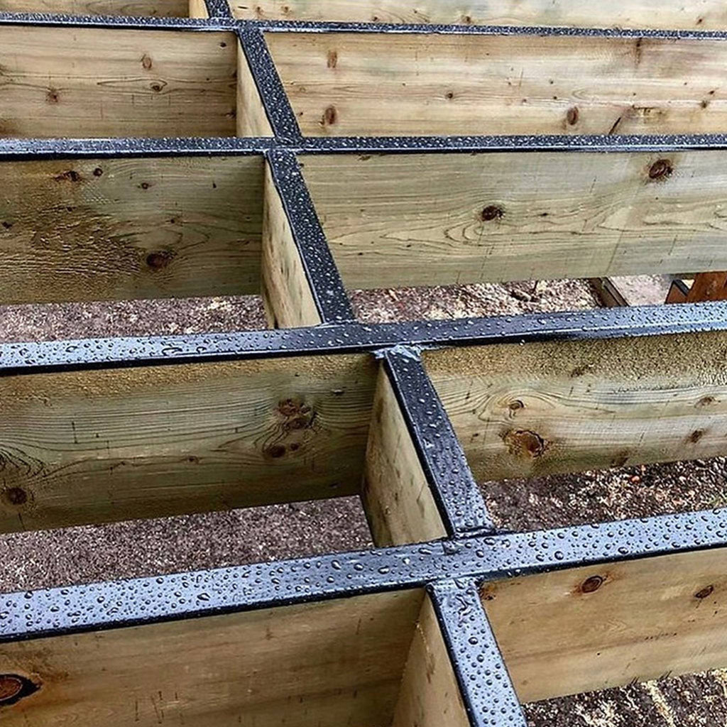 Waterproof GTape black flashing tape installed on deck joists and wooden framing.