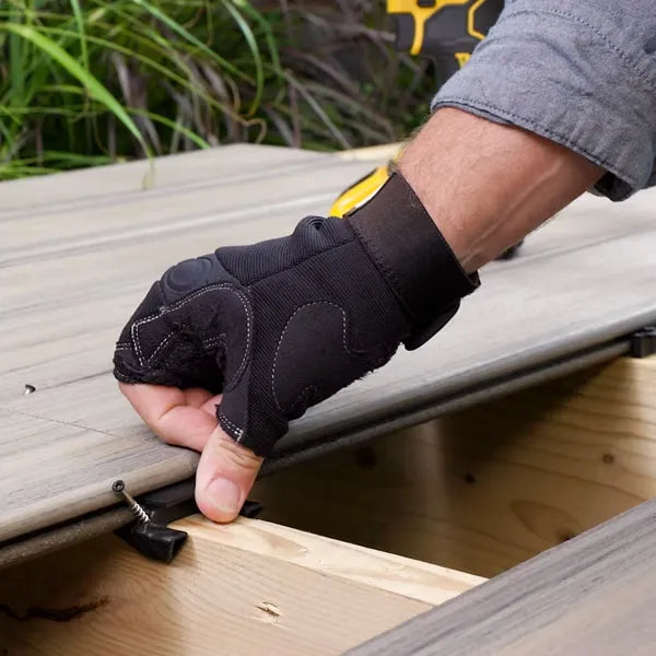 Installing Trex Hideaway Butt Joint Clip into grooved composite deck board on joist