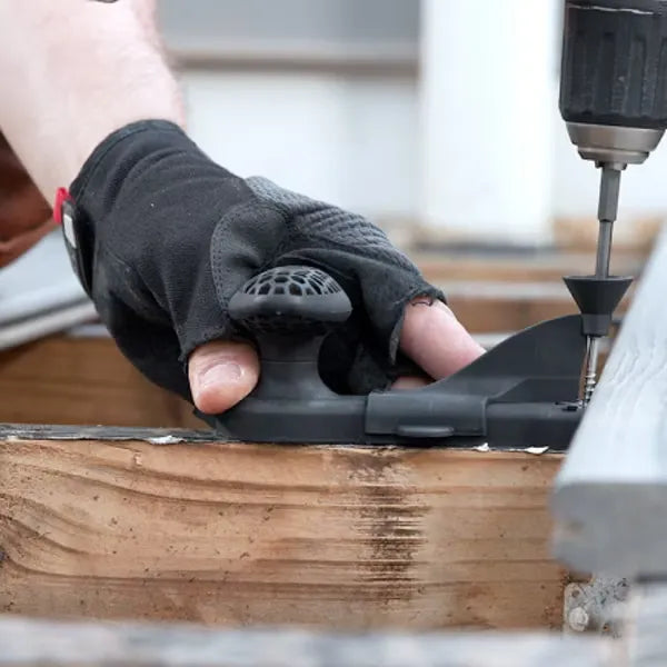 Contractor installing Trex universal hidden fastener using one-step handheld installation tool