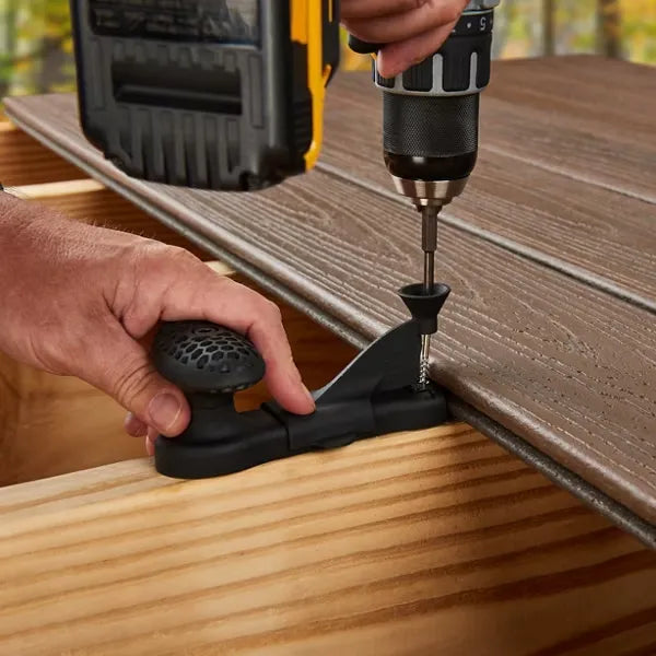 Driving screw through Trex Hideaway Installation Tool into deck joist using drill driver