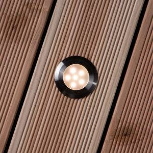 Sirius Decklight with stainless steel 316 finish, installed on a wooden deck, showcasing its warm white LED glow