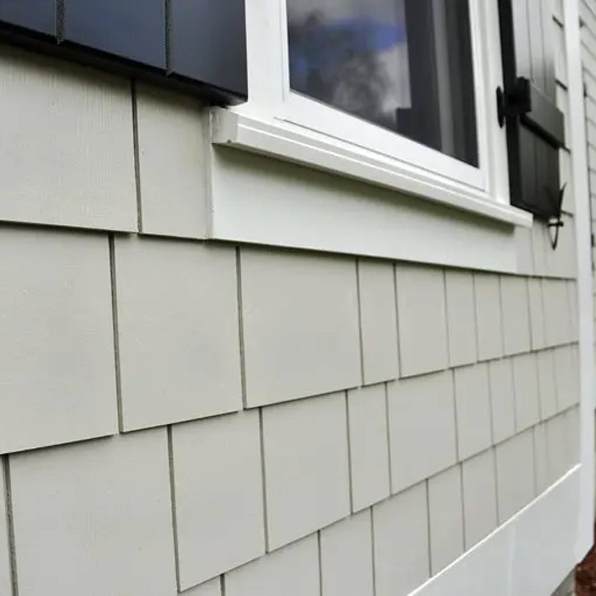 Close-up of fiber cement siding with a textured, durable finish, installed on a modern home exterior.