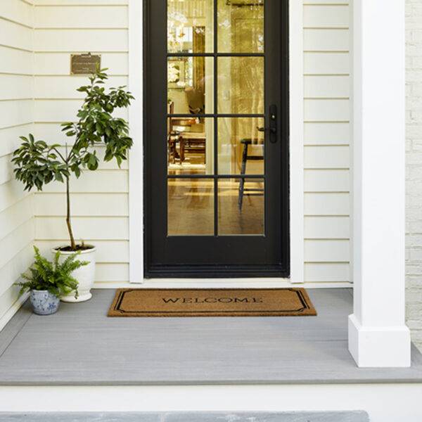 Elegant entryway with AZEK Porch Coastline decking and a welcoming doormat