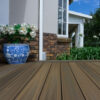 EVA-LAST Infinity Oasis Palm decking with natural wood tone beside garden and brick home